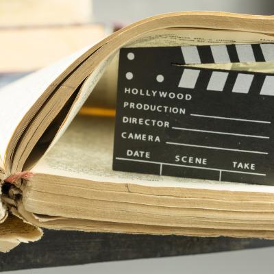 Photo of a movie clapboard in the pages of an old book