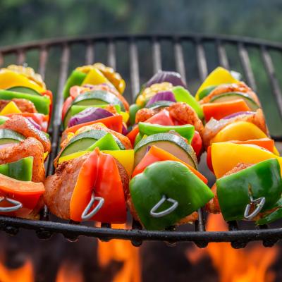 Vegetable skewers cooking on a grill