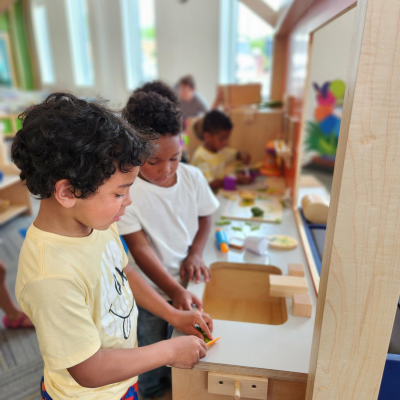 Children playing in play house at Ames Public Library