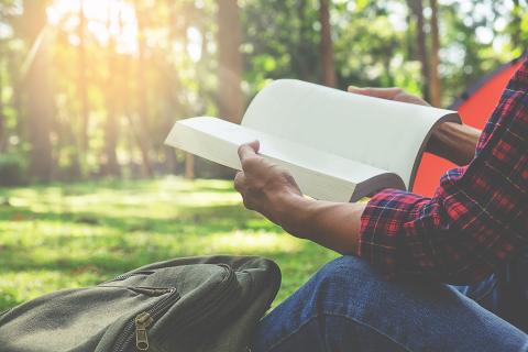 Person reading in natural setting