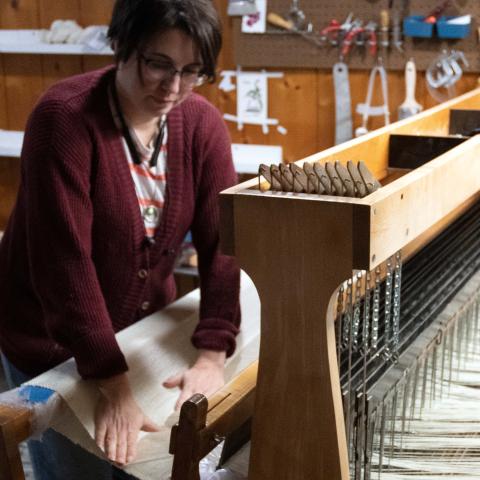 Artist Kristin M Roach weaving tapestry