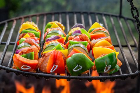Vegetable skewers cooking on a grill